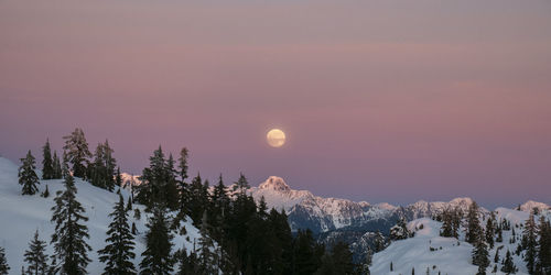 Scenic view of snowcapped mountains against sky during sunset