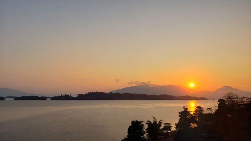 Scenic view of lake against romantic sky at sunset