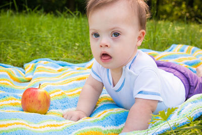 Close-up baby boy on picnic blanket at park