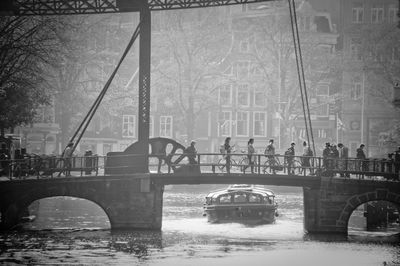Bridge over river in city during winter