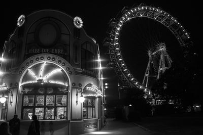 Illuminated ferris wheel at night