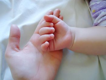 Low section of baby feet on bed