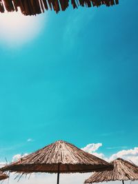 Low angle view of windmill against clear blue sky