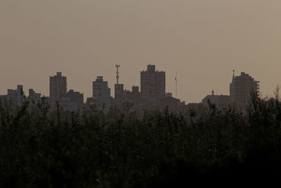 Buildings against clear sky during sunset