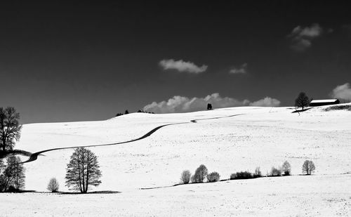 Snow covered landscape against sky