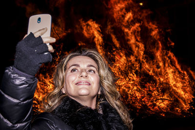 Close-up of man photographing at night