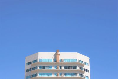 Low angle view of modern building against clear blue sky