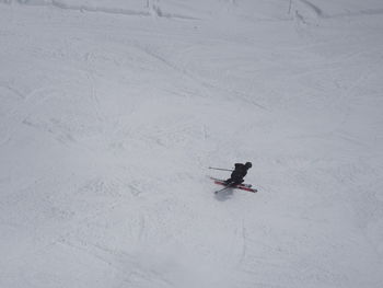 High angle view of person skiing on snow covered field