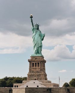 Low angle view of statue against cloudy sky