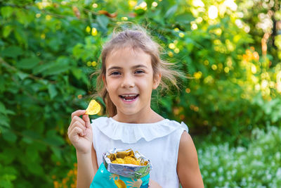 Portrait of girl eating potato chip