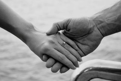 Close-up of couple holding hands