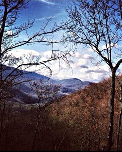 Scenic view of mountains against cloudy sky