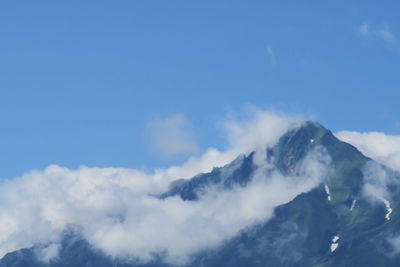 Low angle view of mountains against blue sky