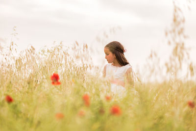 Girl standing in flower field