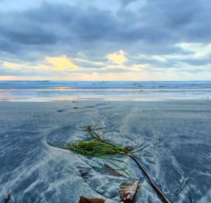 Scenic view of sea against cloudy sky