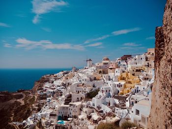 High angle view of townscape by sea against sky