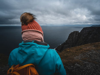 Rear view of person standing against sea