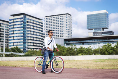 Portrait of young man riding bicycle