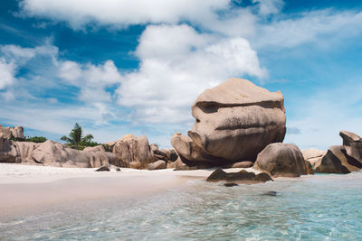 Rocks on beach against sky