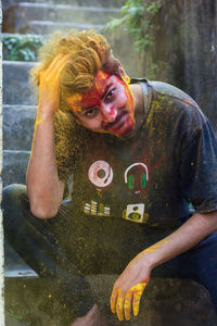 Portrait of young man covered with powder paint