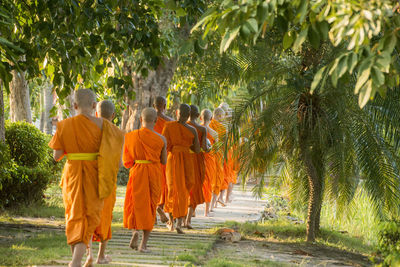 Rear view of monks walking in temple