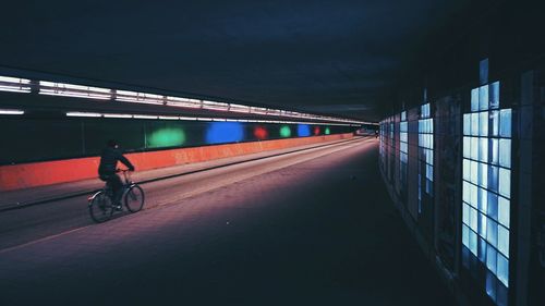 Man in illuminated tunnel