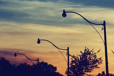 Low angle view of silhouette street light against sky at sunset