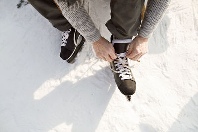 Man putting on ice skates