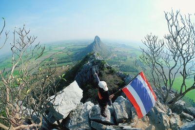 Man holding thai flag on mountain