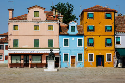 Vibrant houses along the canal in burano, italy, highlight unique architecture 