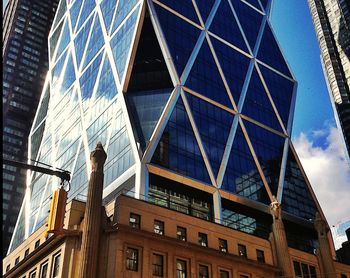 Low angle view of modern building against blue sky