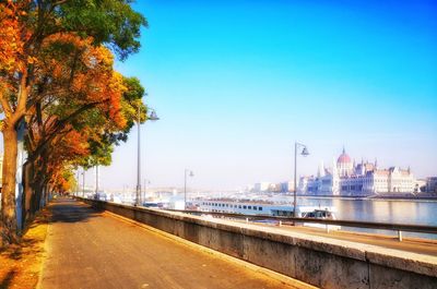 City by river against clear sky