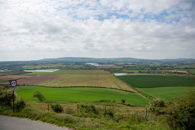 Scenic view of agricultural field against sky