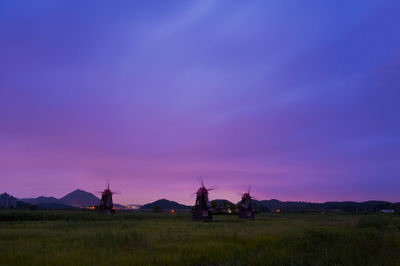 Scenic view of field against sky at sunset