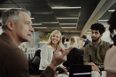 Group of business people having meeting in lobby