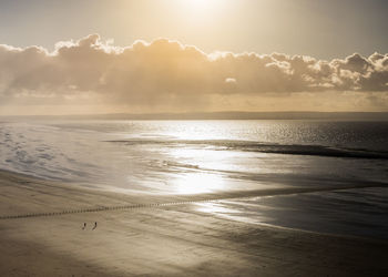 Scenic view of beach against sky during sunset