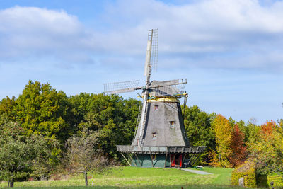 Low angle view of windmill against sky