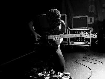 Rear view of man playing guitar