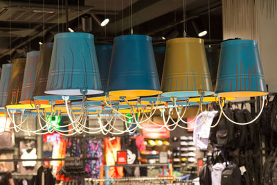 Creative lamps in the form of metal buckets in a clothing store.