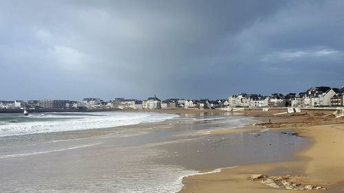 View of beach against cloudy sky