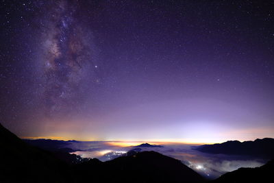 Scenic view of mountains against sky at night