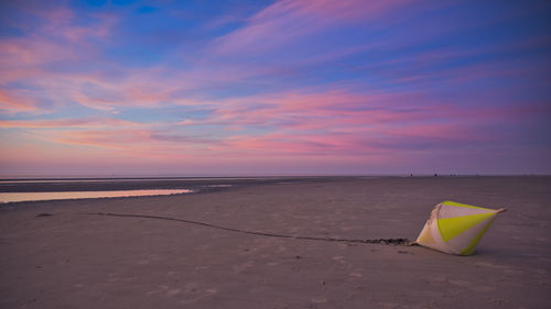 Scenic view of beach against sky during sunset