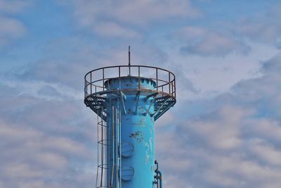 Low angle view of water tower against cloudy sky