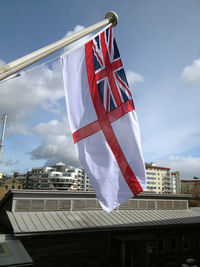 Low angle view of royal navy flag against sky