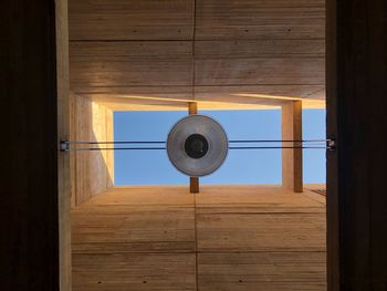 Directly below shot of pendant light hanging on glass ceiling