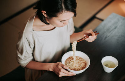 Midsection of woman holding food at home