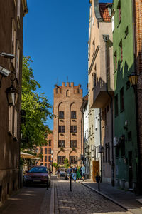 Street amidst buildings against sky in city