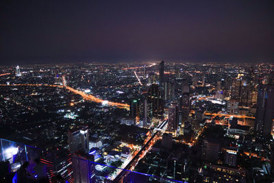 High angle view of illuminated city buildings at night