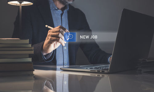 Midsection of woman using laptop on table