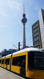 Low angle view of train against sky in city